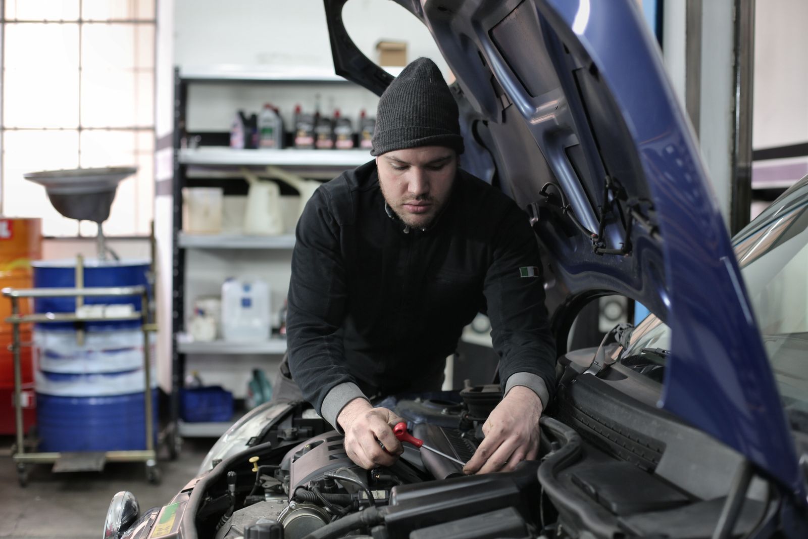 Mechanic working on a car engine in the shop